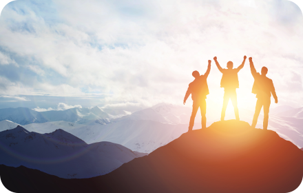 Team celebrating success on mountain top
